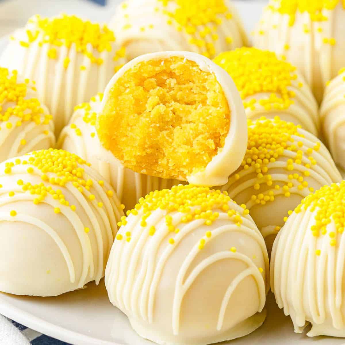 Front close up of Lemon Cake Balls a bite taken from the top one.