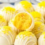Front close up of Lemon Cake Balls a bite taken from one.