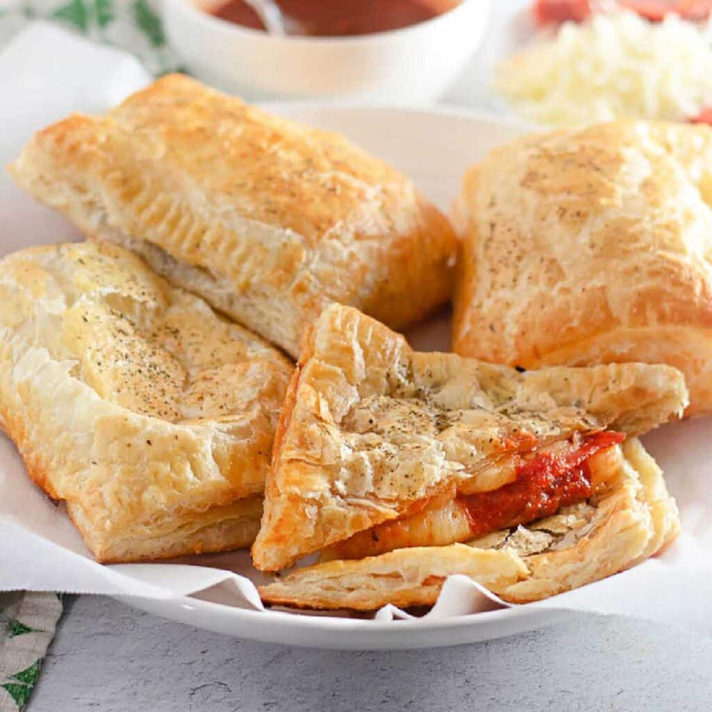 Close up of Puff Pastry Pizza Pockets one cut opened.