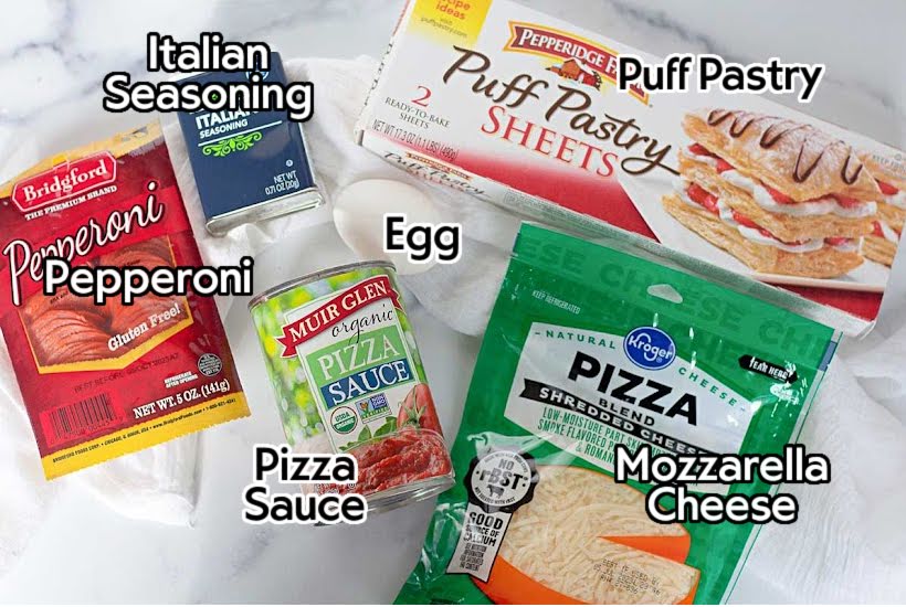 Ingredients needed to make homemade pizza pockets with puff pastry with text labels.