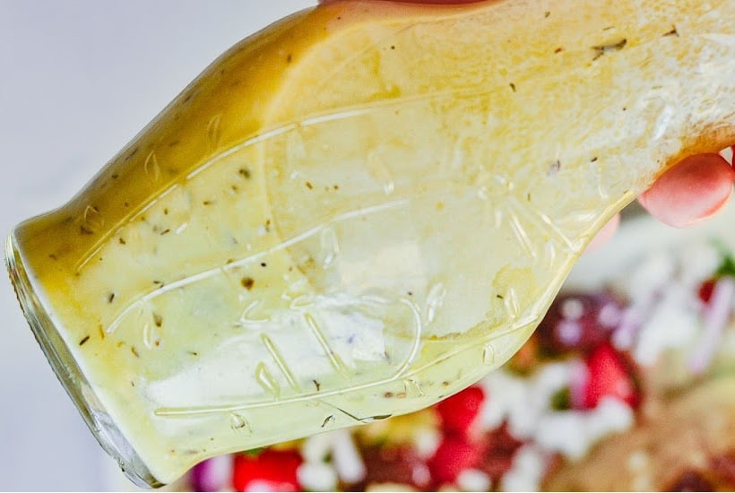 Homemade dressing with Greek yogurt in a glass decanter.