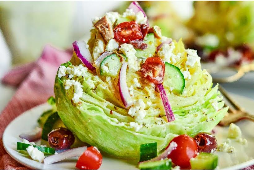 Closeup view of Greek wedge salad on a plate.