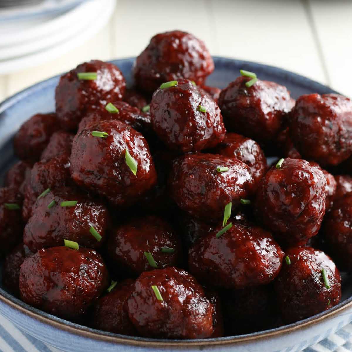 Crockpot Meatballs with Grape Jelly and BBQ Sauce in a serving bowl.