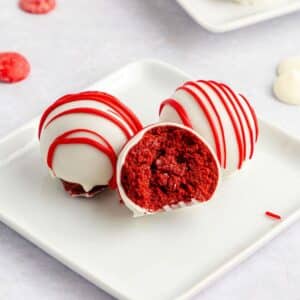 Red Velvet Cake Balls on a small dish, one cut in half.