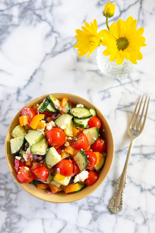 A chopped salad with tomatoes and cucumbers.