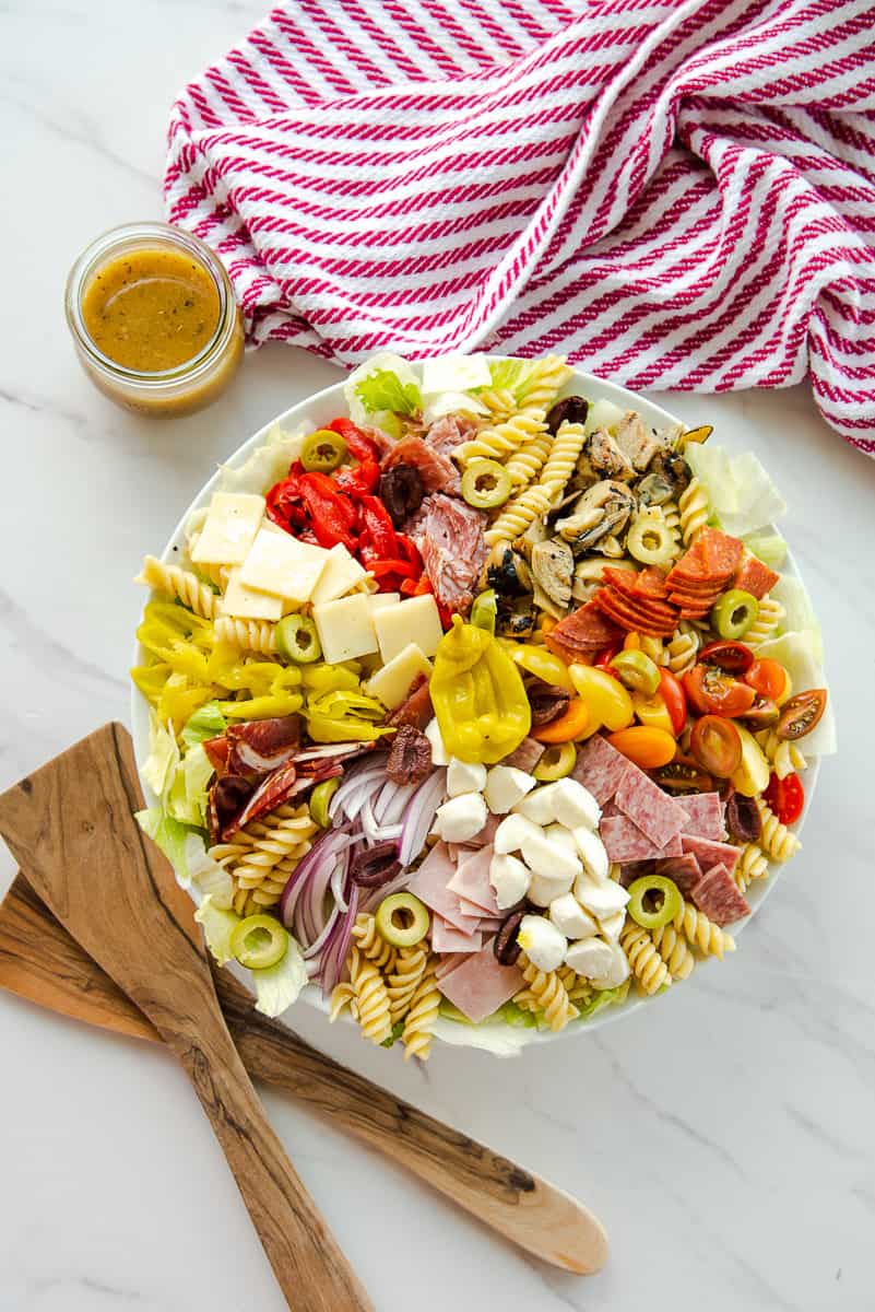 A bowl of pasta salad with antipasto ingredients.