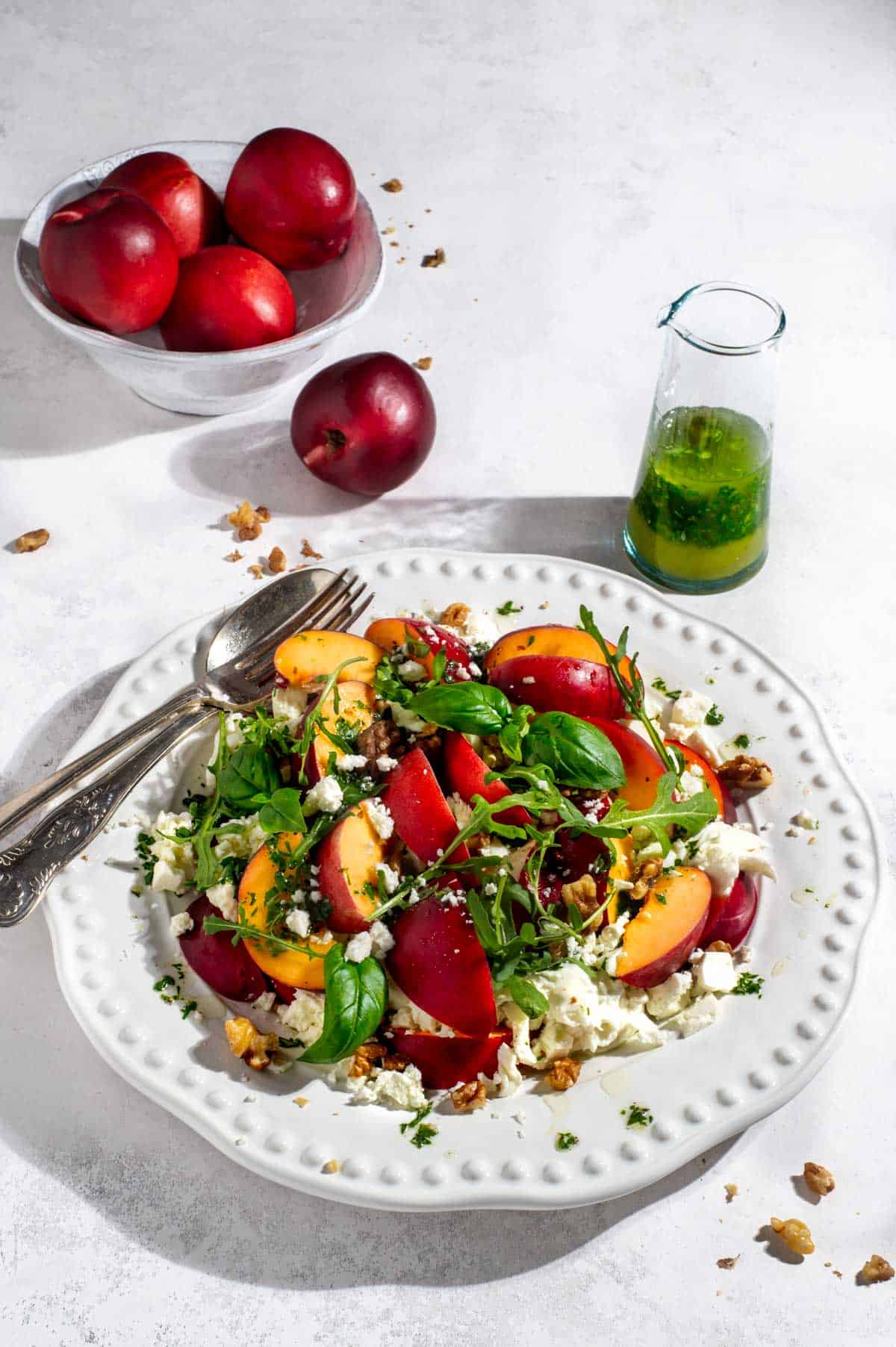 Salad made with leafy greens and nectarines.