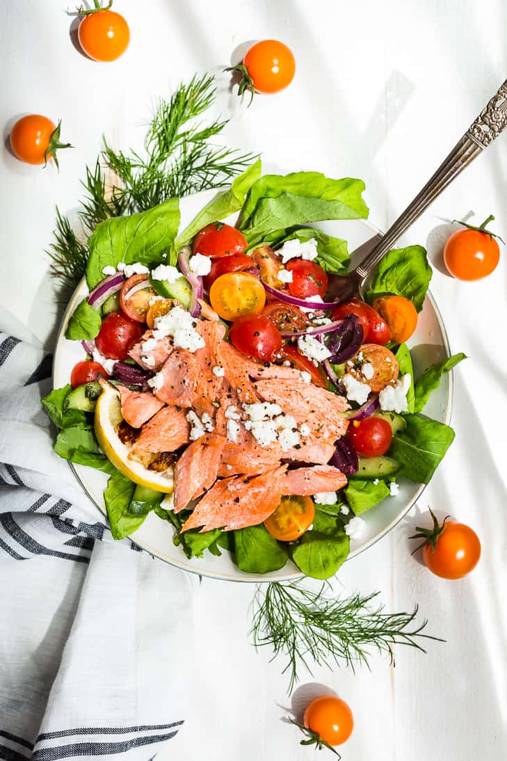 A chopped tomato salad with salmon shredded over the top.