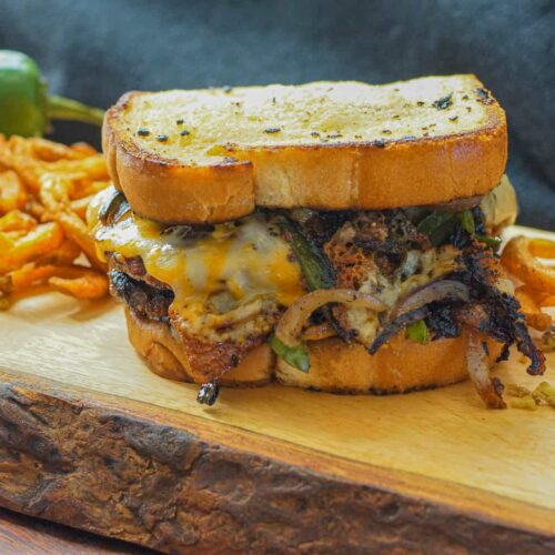 Smash burger with grilled onions and cheese on Texas toast.
