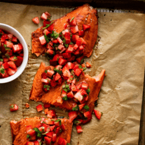 Sliced salmon filet topped with strawberry salsa.