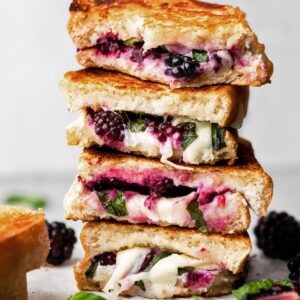 A stack of blackberry caprese grilled cheese sandwiches.