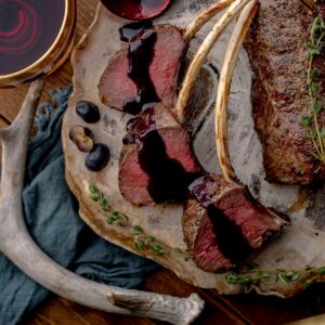 Venison chops topped with blueberry thyme sauce.