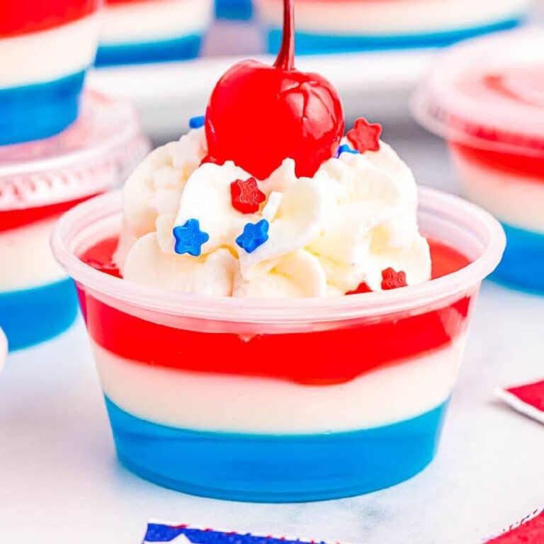 red, white and blue jello shot with whipped cream and cherry