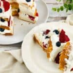 A layered angel food cake with berries and whipped cream.