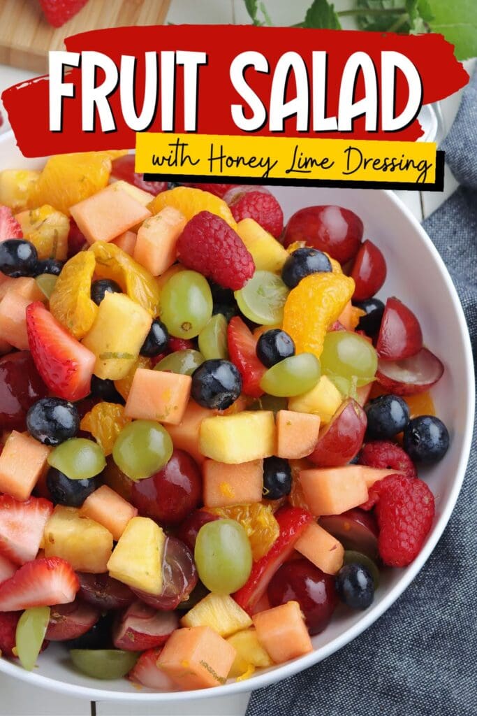 Top view of white bowl filled with fresh chopped fruit salad with text overlay.