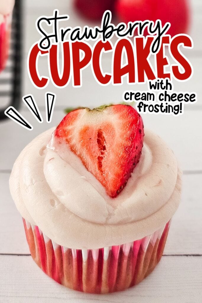 Closeup view of a strawberry cupcake topped with cream cheese frosting and half a strawberry with text overlay.
