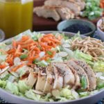 Closeup of a bowl of Chinese chicken salad with crunchy noodles.