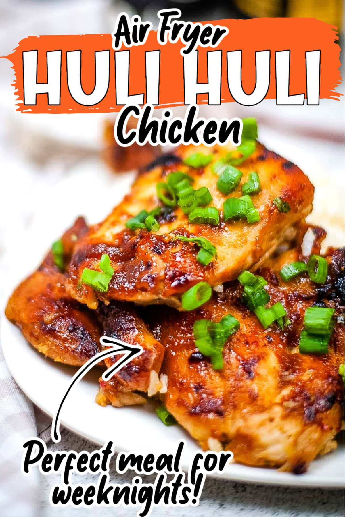 Closeup view of Hawaiian BBQ Huli Huli chicken made in the air fryer and garnished with chopped green onions with text overlay.