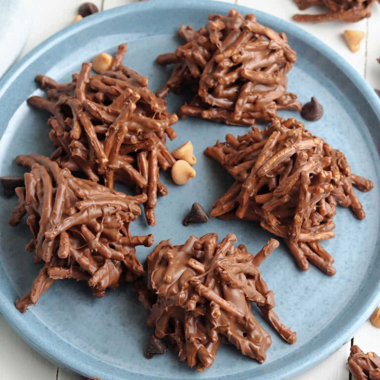 No bake chocolate peanut butter haystack cookies with chow mein noodles on a blue plate.