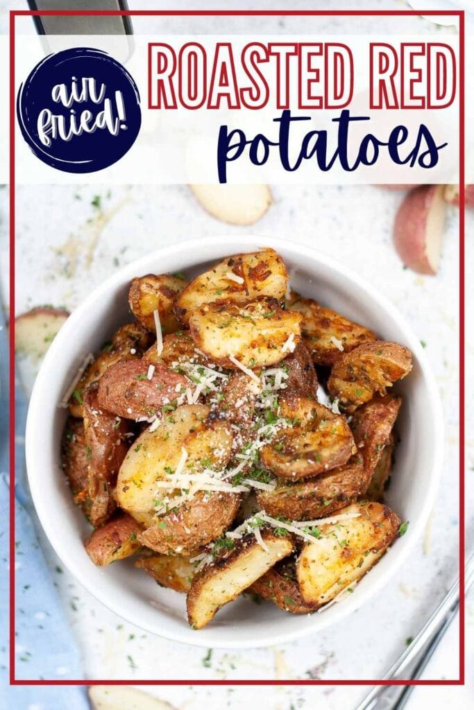 Air fried roasted red potatoes garnished with chopped parsley and parmesan in a white bowl with text overlay.