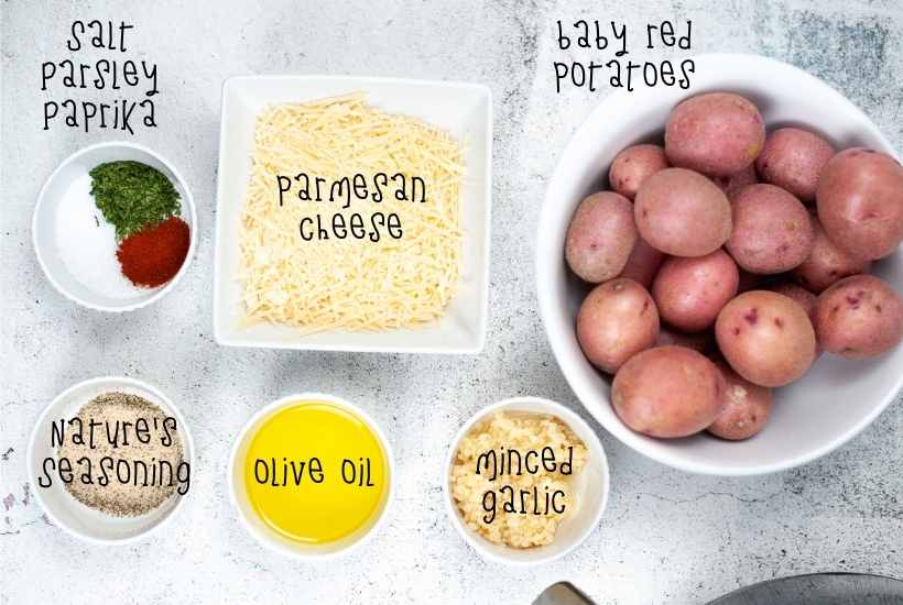 Ingredients to make roasted red potatoes in the air fryer in white dishes with text labels.