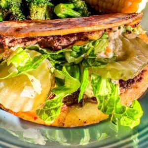 Smash burger Big Mac wrap garnished with lettuce and pickles.