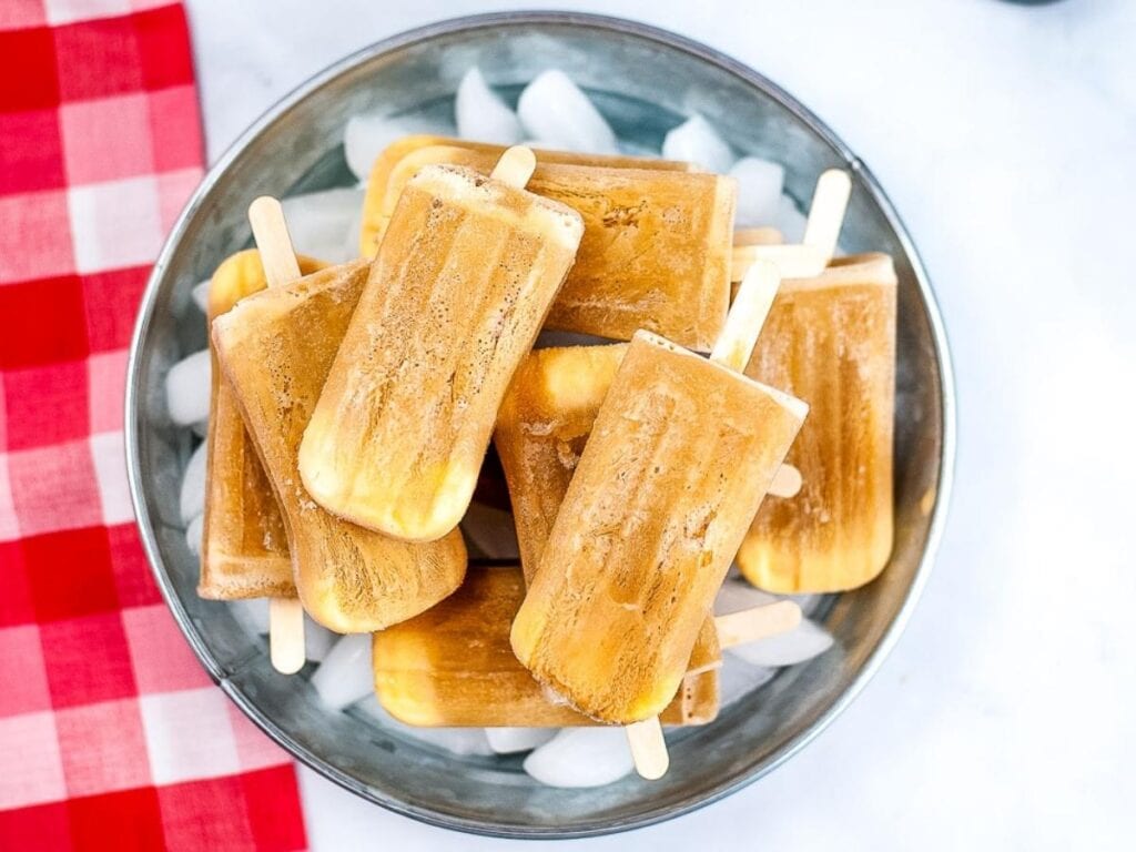 Overhead view of old fashioned root beer float pops stacked on ice.