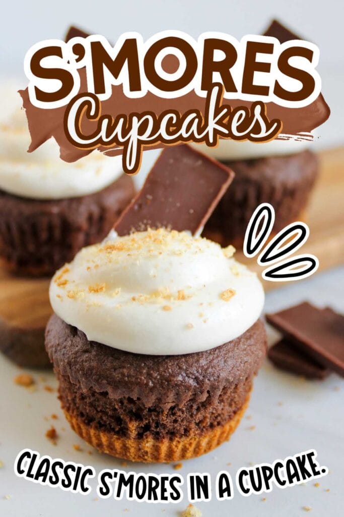 Closeup view of smores cupcakes with graham cracker base and whipped marshmallow fluff frosting and garnished with crushed graham crackers and a piece of chocolate with text overlay.