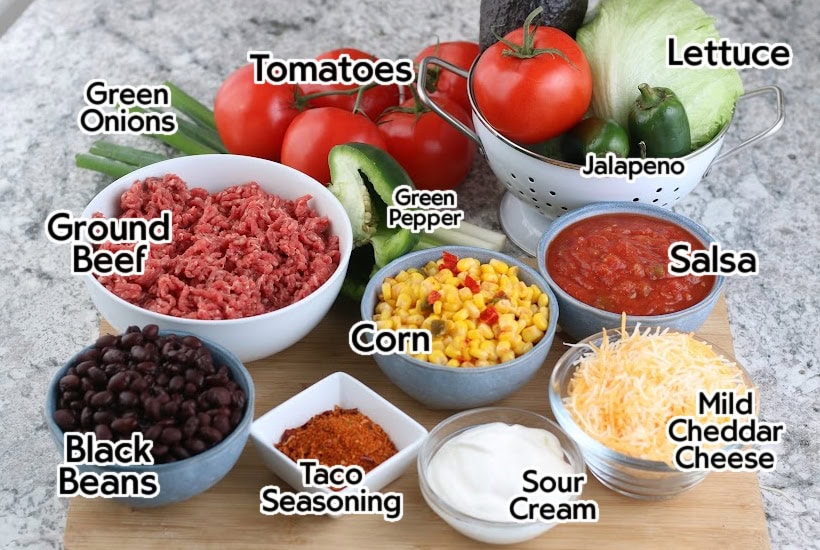 Ingredients to make classic taco salad recipe with text labels.