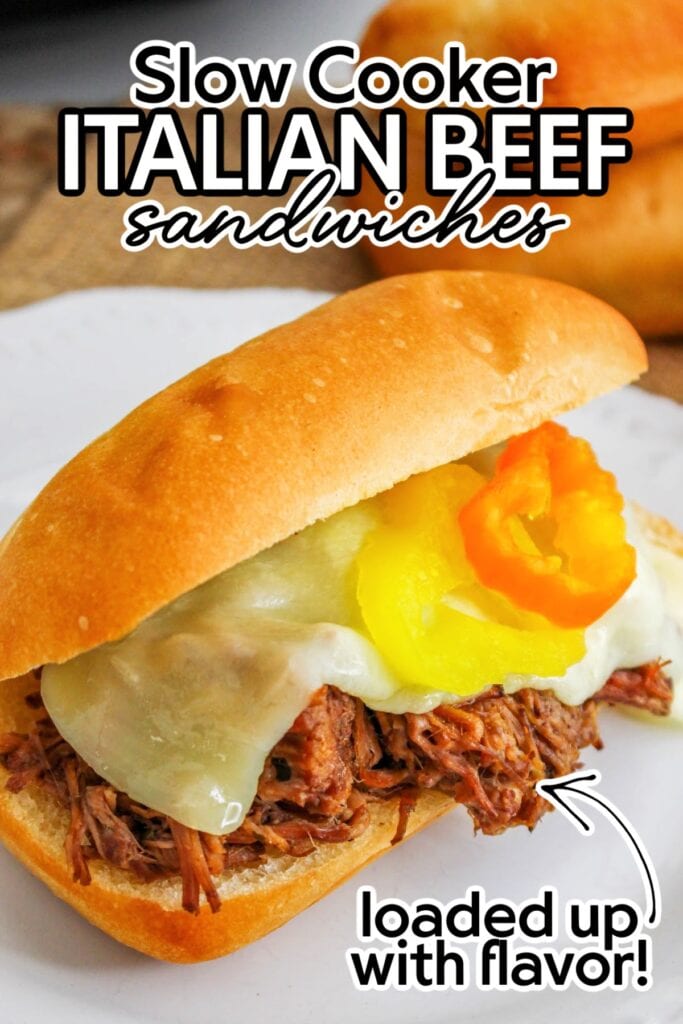 Slow cooker Italian beef sandwich with provolone cheese and pepperoncini peppers with text overlay.