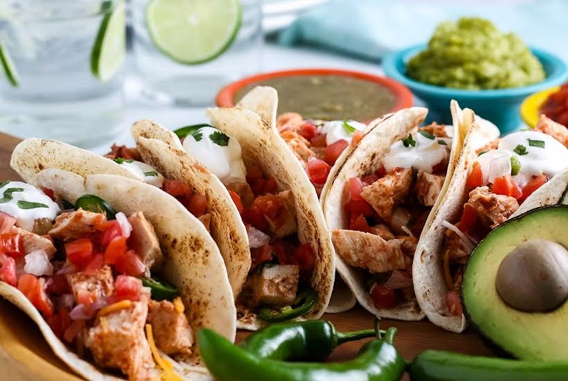 Slow cooker chicken tacos with avocado, salsa, and lime.