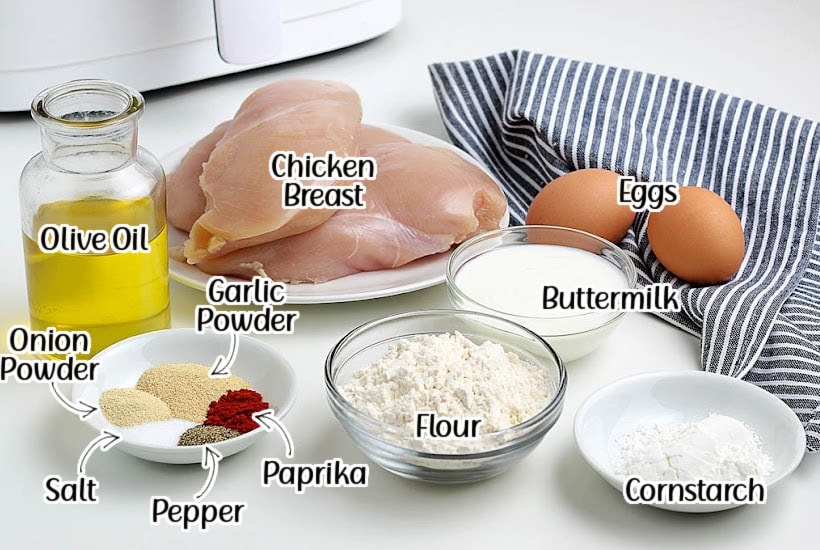 Ingredients needed to make homemade air fryer popcorn chicken recipe with text labels.