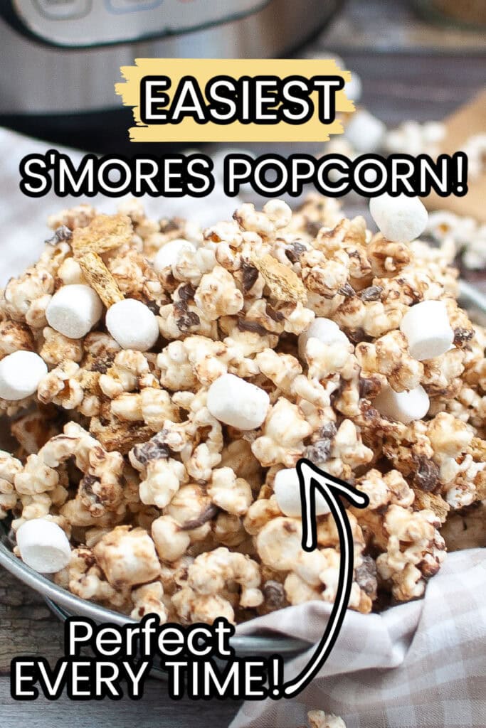 Closeup of view of a metal bowl filled with homemade smores popcorn recipe with a tan checked towel.