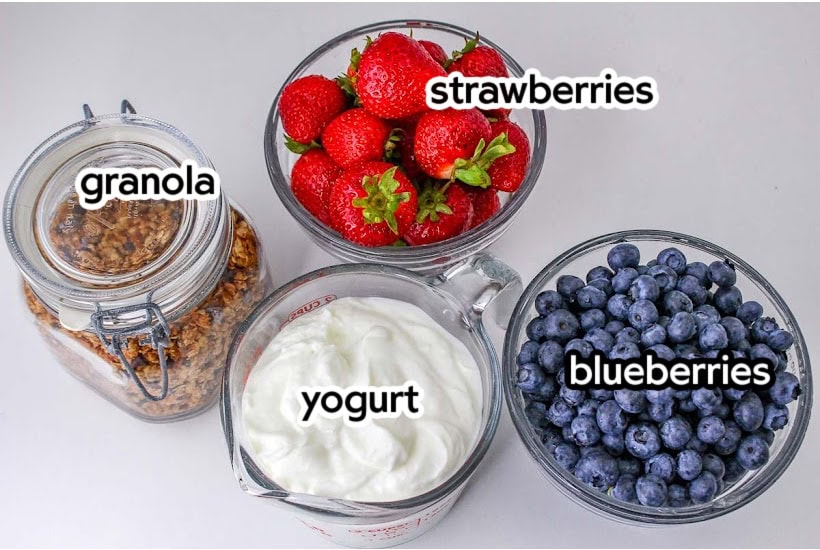 Ingredients needed to make greek yogurt parfaits with text labels.