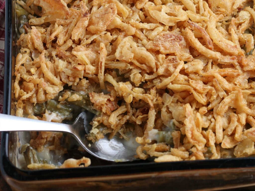 Closeup view of French green bean casserole recipe topped with crispy fried onions.