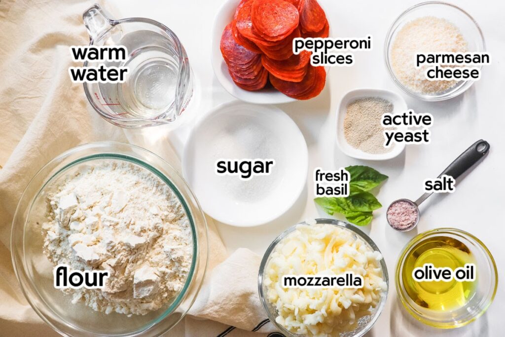 Ingredients needed to make pepperoni pizza pinwheels with text labels.