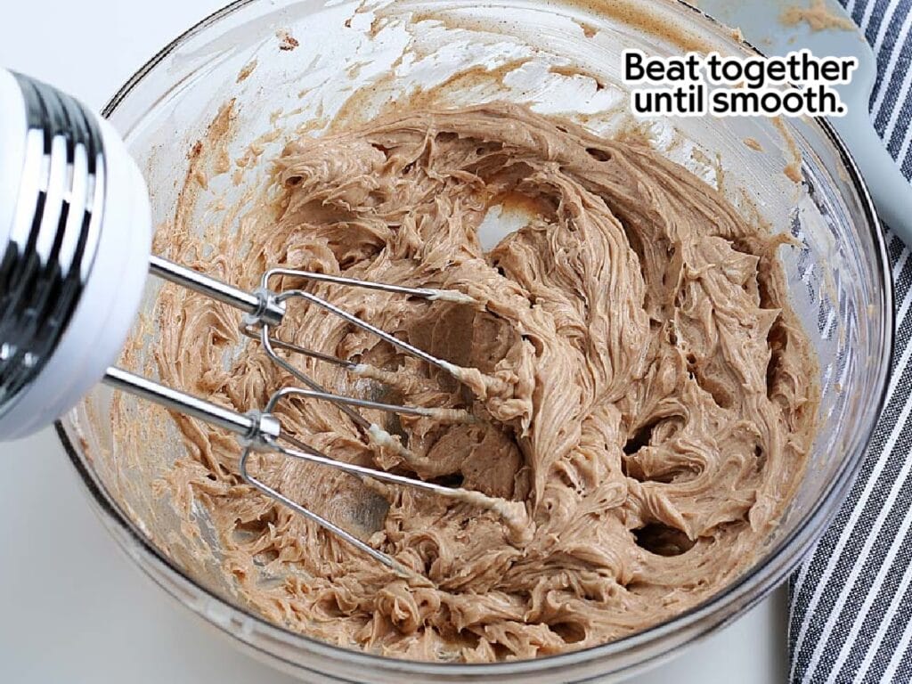 Beating all of the cinnamon and honey butter ingredients together in a mixing bowl with text overlay.