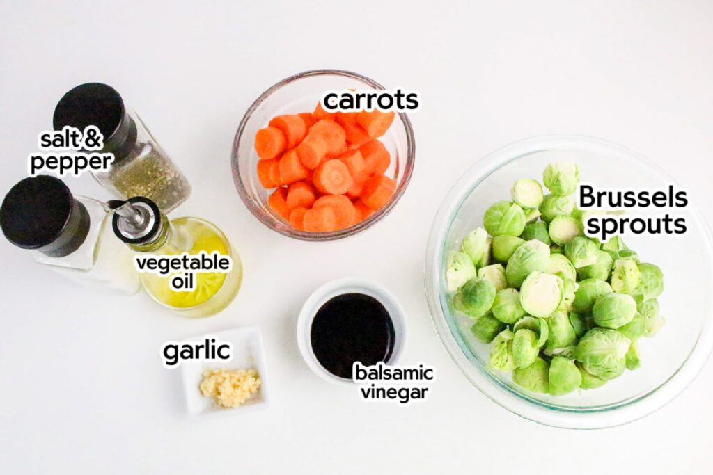 Ingredients needed to make roasted brussel sprouts and carrots with text labels.