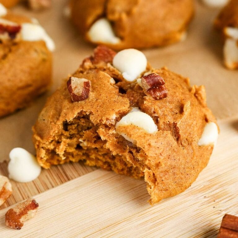 A Cake Mix Pumpkin Spice Cookie with a bite removed and surrounded by more cookies.